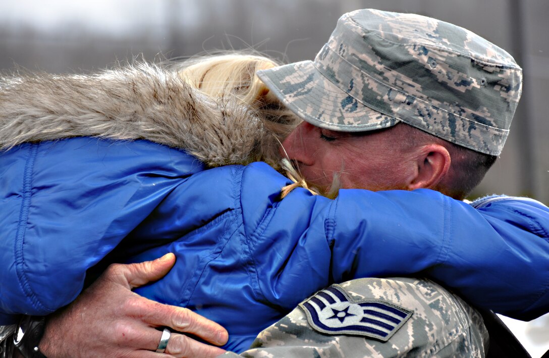 Staff Sgt. John Davis, 911th Security Forces Squadron receives a warm welcome home hug from his daughter Hayley, 10, at the Pittsburgh International Airport Air Reserve Station, Feb. 27, 2014. Regardless of the weather and temperatures in the teens, it did not prevent family members from bundling up and gathering outside the Security Forces Squadron to immediately greet their loved ones upon their return.  Tears froze and hugs were long, for all thirteen SFS personnel who returned safely from the deployment, which began last October.  All unit members provided Base Defense Operations support for the 64th Expeditionary Security Forces Squadron in Saudi Arabia. (Photo by U.S. Air Force Capt. Shawn M. Walleck)  