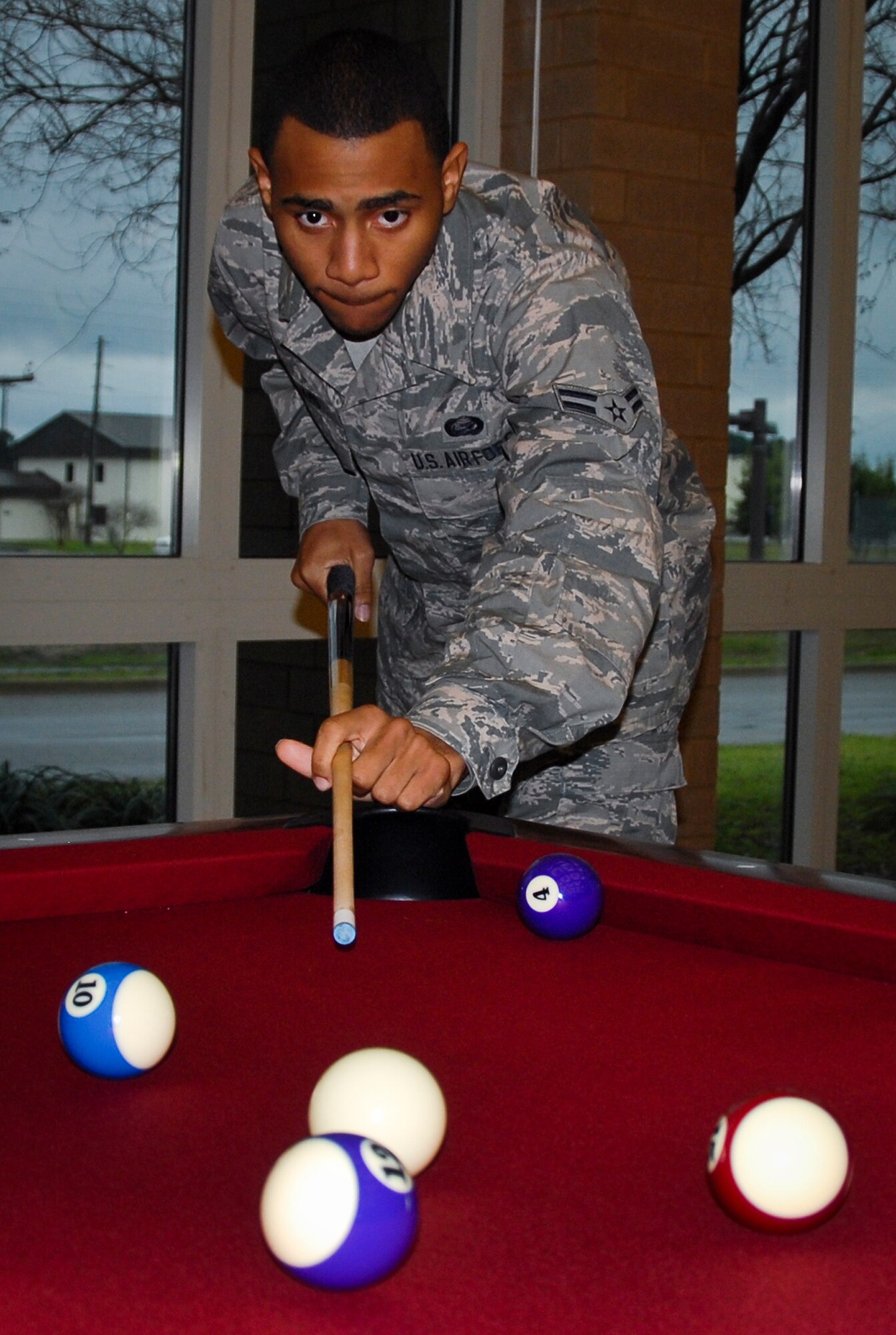 An Airman plays pool at Hangar 3, Eglin’s new digital library.  It is part of Community Commons, which combines access to 96th Force Support Squadron programs and information into one convenient location. (U.S. Air Force photo/Kevin Gaddie)