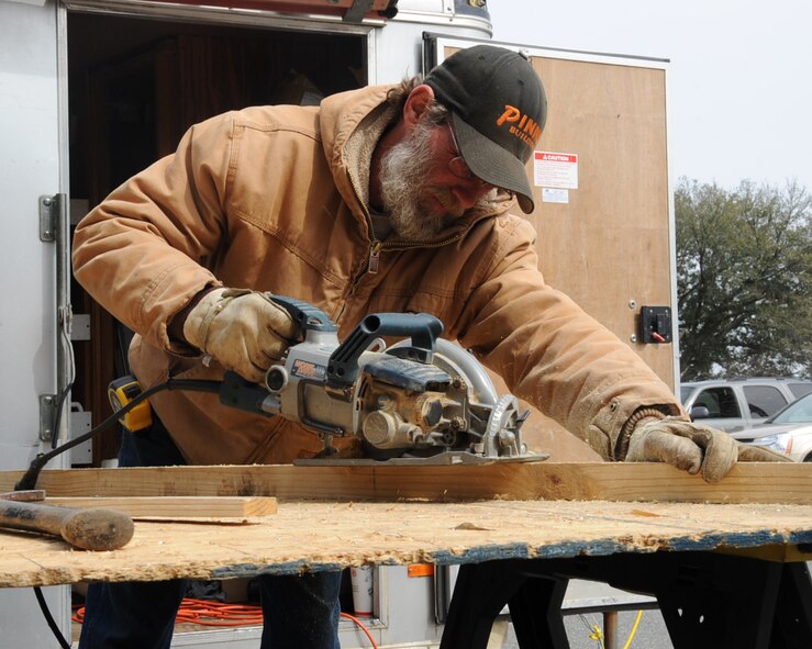 Jim Parker, local contractor, cuts a piece of wood to be used with the installation a window in a dormitory on Barksdale Air Force Base, La., Feb. 25, 2014. The 2nd Civil Engineer Squadron Dorm Management office is in the process of renovating various dorms on Barksdale as a way to promote a better quality of life for Airmen.  (U.S. Air Force photo/Staff Sgt. Sean Martin)