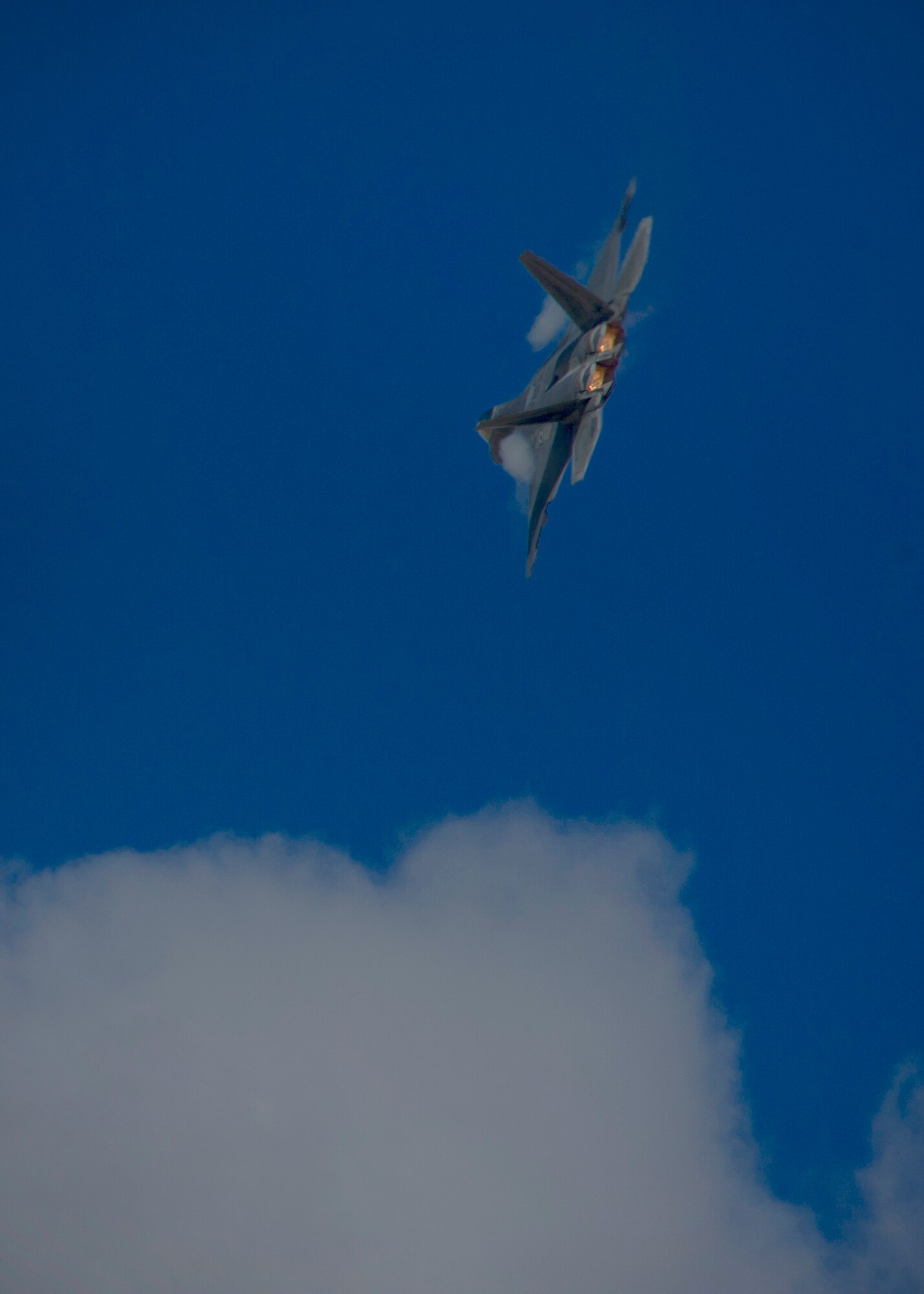 Captain John Cummings, F-22 Raptor Demo Team pilot, performs maneuvers during a practice run of the F-22 aerial demonstration used at events at Holloman Air Force Base, N.M., Feb. 4. The F-22 Demo Team will perform twice during the upcoming Open House held at Holloman on May. 10. (U.S. Air Force photo by Airman 1st Class Aaron Montoya/Released)