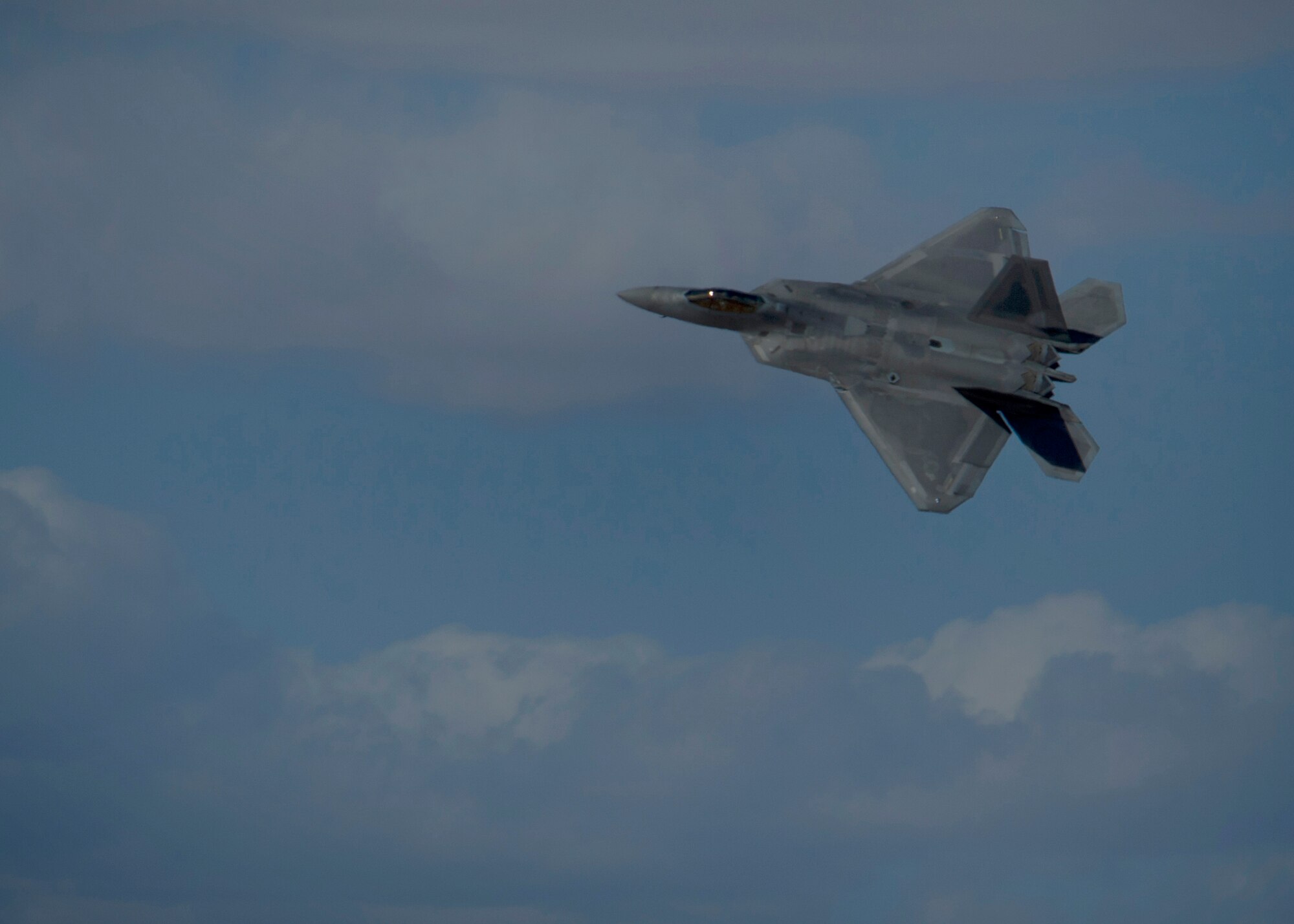 Captain John Cummings, F-22 Raptor Demo Team pilot, performs maneuvers during a practice run of the F-22 aerial demonstration used at events at Holloman Air Force Base, N.M., Feb. 4. The F-22 Demo Team will perform twice during the upcoming Open House held at Holloman on May. 10. (U.S. Air Force photo by Airman 1st Class Aaron Montoya/Released)