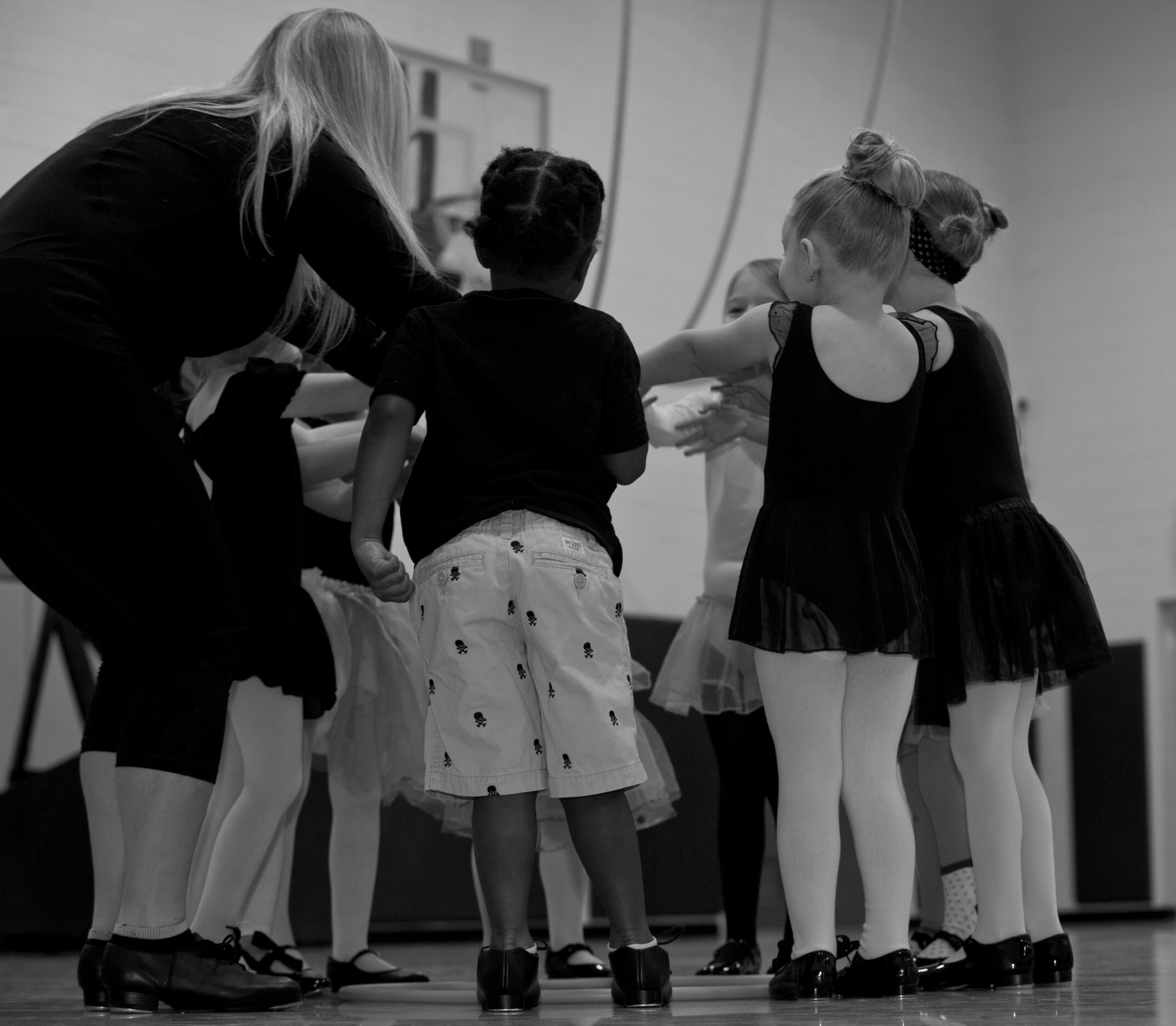 Rebecca Hulun teaches her students the basic fundamentals of ballet, jazz and tap dancing, at Holloman Air Force Base, N.M., Youth and Teen Center Feb. 25. Hulun is the director and dance teacher of the DS Dance Academy that holds classes in the Youth and Teen Center gymnasium. She teaches a variety of dance classes for students ages toddler to 12 years old. (U.S. Air Force photo by Airman 1st Class Leah Ferrante/Released) 
