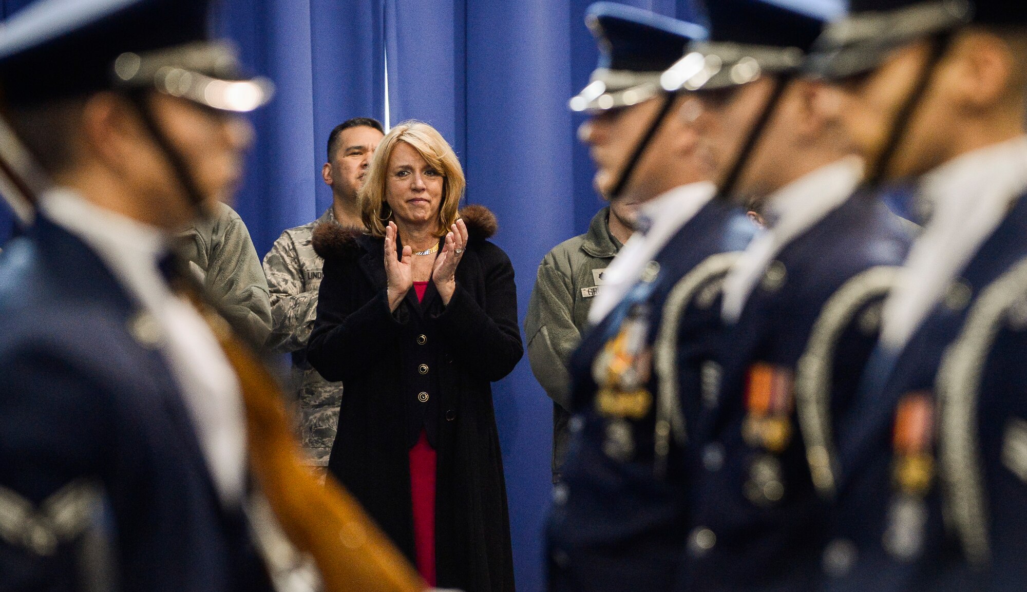 Secretary of the Air Force Deborah Lee James applauses the performance of The U.S. Air Force Honor Guard Drill Team during an immersion tour at Joint Base Anacostia-Bolling, D.C., Feb. 7, 2014. A standard USAF Drill Team performance features a professionally choreographed sequence of show-stopping weapon maneuvers, precise tosses, complex weapon exchanges, and a walk through the gauntlet of spinning weapons. (U.S. Air Force photo/Jim Varhegyi)
