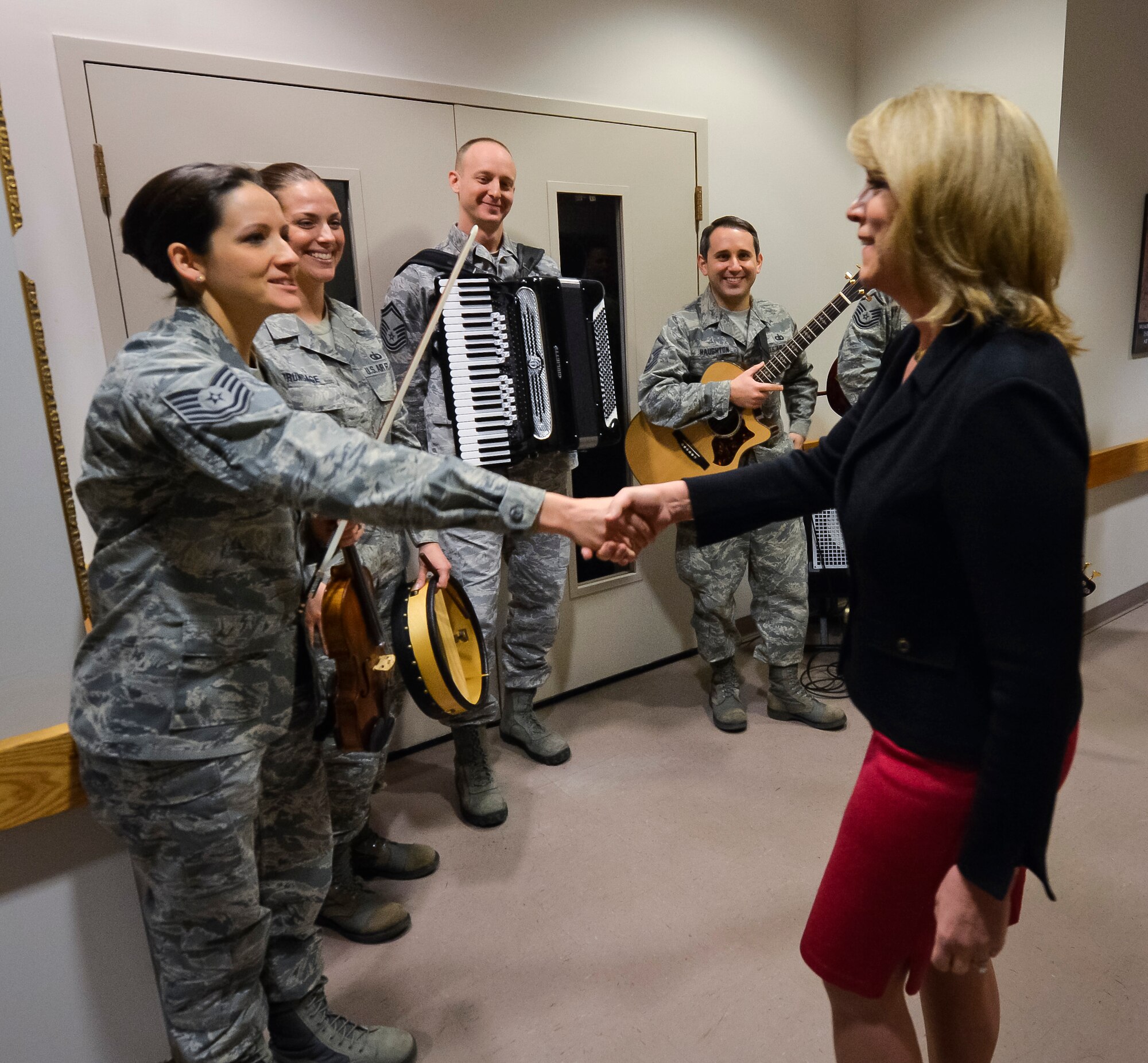 Secretary of the Air Force Deborah Lee James greets Tech. Sgt. Emily Wellington during an immersion tour at Joint Base Anacostia-Bolling, D.C., Feb. 7, 2014. Wellington is a vocalist and violinist with The U.S. Air Force Band’s Celtic Aire ensemble and an alto vocalist with the Singing Sergeants. Celtic Aire is one of many small ensembles from within the Band that performs for protocol and ceremonial functions, as well as public events.  (U.S. Air Force photo/Jim Varhegyi)