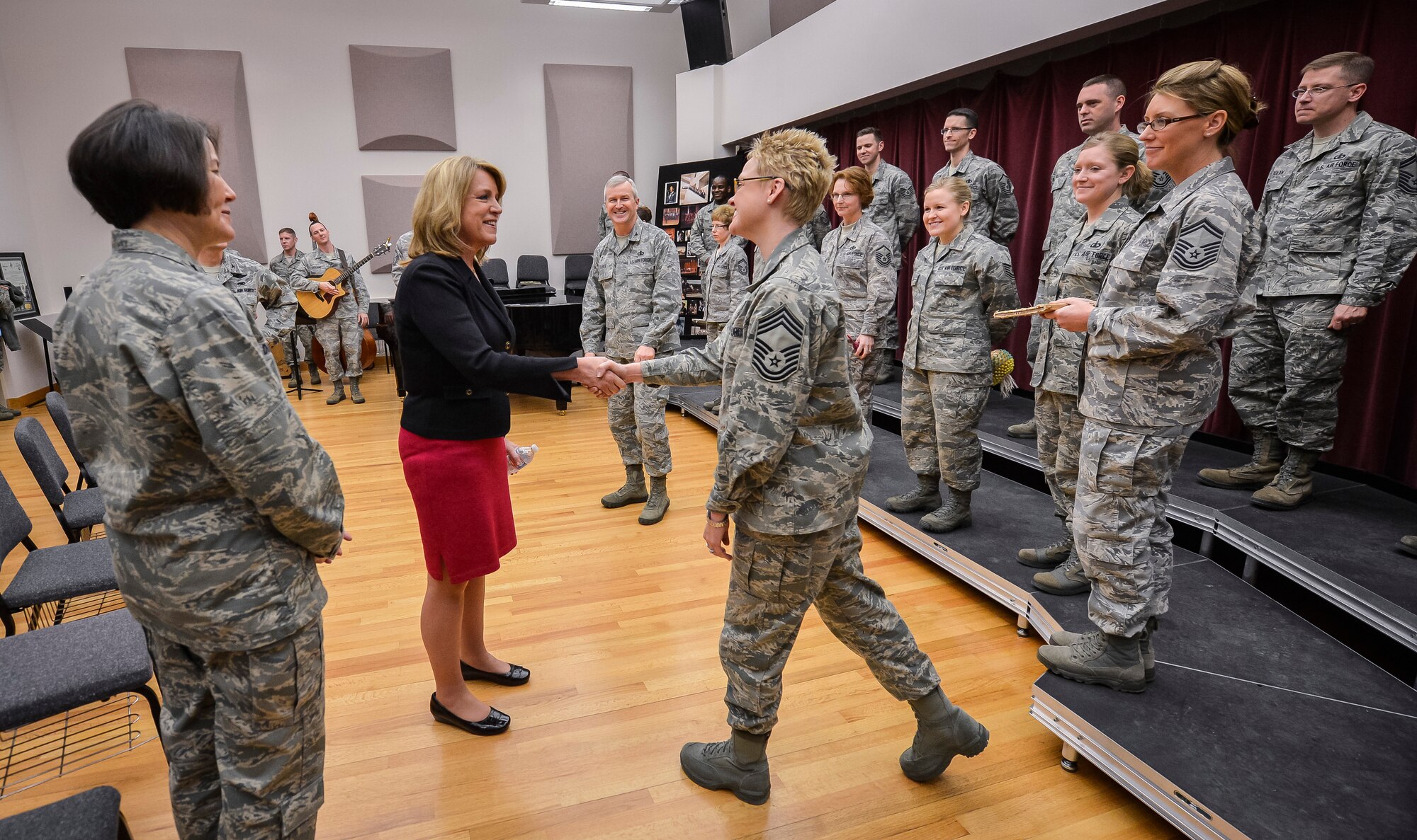 Secretary of the Air Force Deborah Lee James greets Chief Master Sgt. Angela Burns before Airmen from The U.S. Air Force Band ensemble the Singing Sergeants perform for her during an immersion tour at Joint Base Anacostia-Bolling, D.C., Feb. 7, 2014. Burns is an alto vocalist and the flight chief of the Singing Sergeants. Originally formed in 1945 from the ranks of The United States Army Air Forces Band, the chorus has a long heritage of excellence. It is comprised of 18 professional Airmen vocalists, recruited from the finest colleges, universities and music conservatories to serve as active-duty musicians in the Air Force. (U.S. Air Force photo/Jim Varhegyi) 