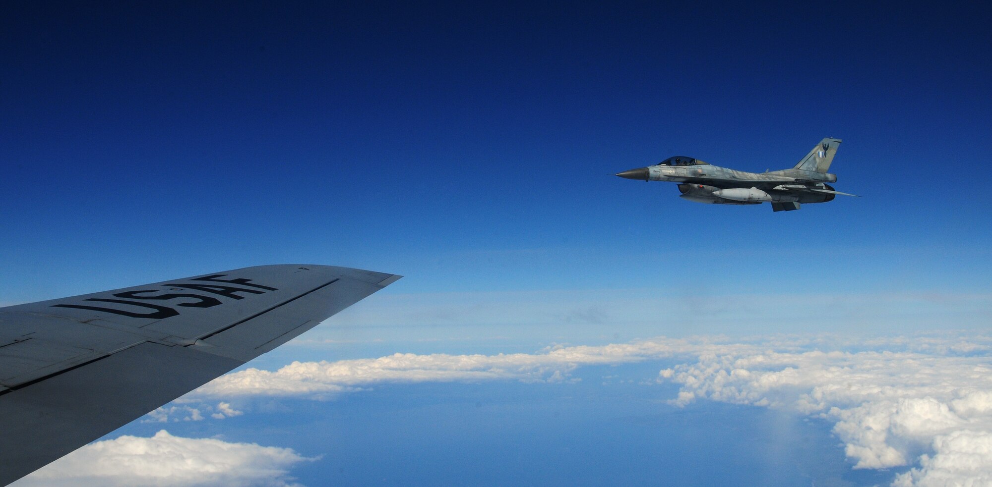 An Hellenic air force F-16 fighter jet flies off the wing of a U.S. Air Force KC-135 Stratotanker during a training mission over the Mediterranean Sea, Feb. 26, 2014. The KC-135 is deployed from Royal Air Force Mildenhall, England. Greek and U.S. air forces are undergoing two weeks of NATO training out of Souda Air Base, Greece. (U.S. Air Force photo by Staff Sgt. Thomas Trower/Released)
