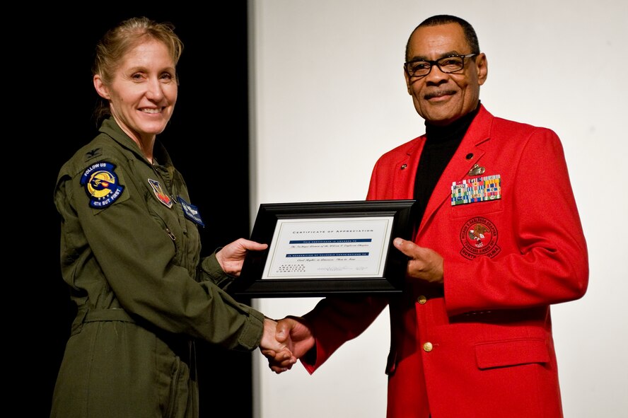 Col. Jeannie Leavitt, 4th Fighter Wing commander, presents Dr. Thomas Smith, vice president of the Wilson V. Eagleson Chapter of Tuskegee Airmen, located in the city of Goldsboro, N.C., with a certificate of appreciation during a forum entitled “Civil Rights in America: Then to Now,” Feb. 26, 2014, at Seymour Johnson Air Force Base, N.C.  Smith, and other members of the chapter, spoke with Airmen during the forum about the challenges they faced during their service.  (U.S. Air Force photo/Airman 1st Class Brittain Crolley)