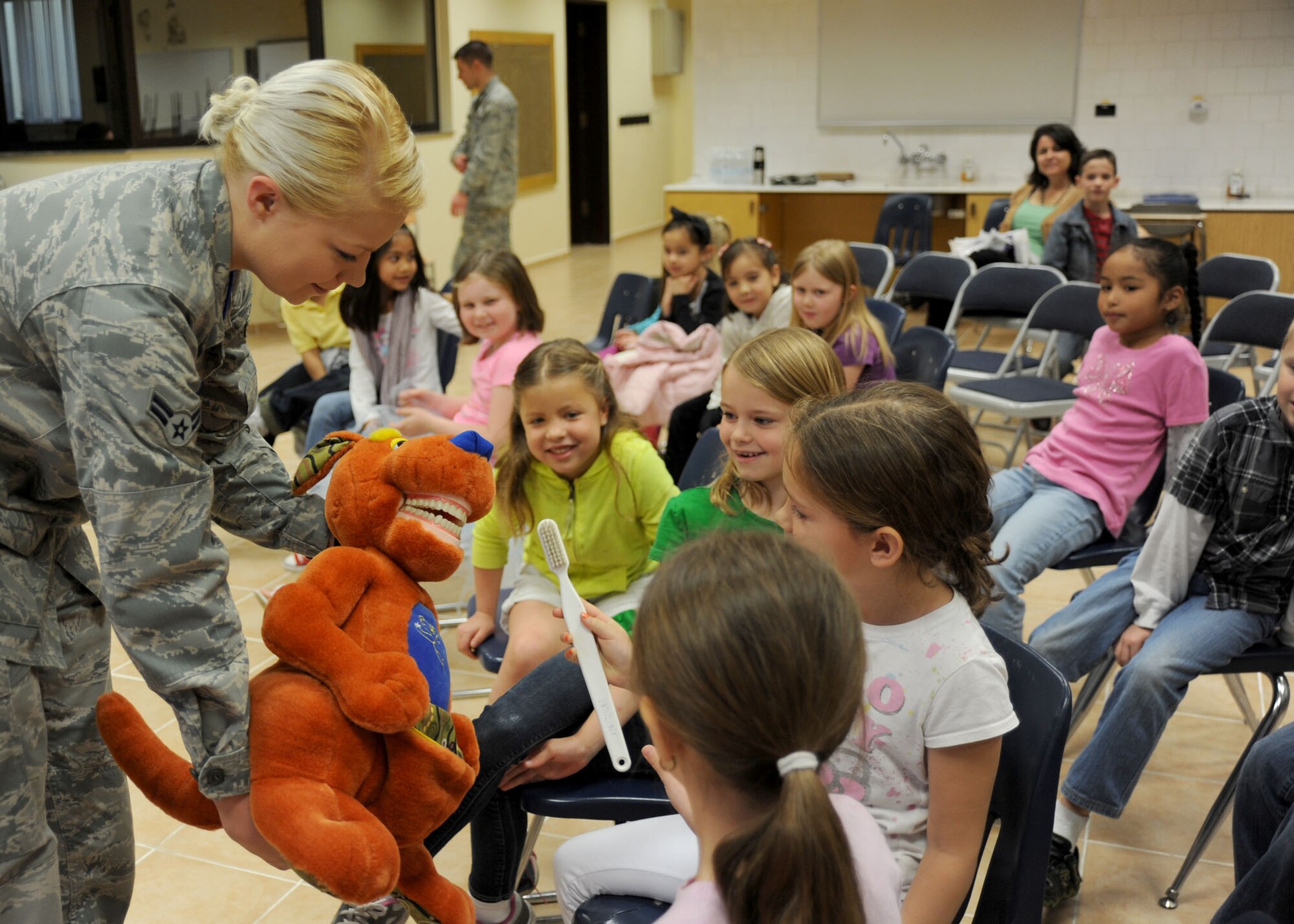 INCIRLIK AIR BASE, Turkey— Airman 1st Class Shelby McIntyre, 39th Medical Group dental technician, teaches students at the Incirlik Unit School  the correct way to brush teeth Feb. 26, 2014, Incirlik Air Base, Turkey.  The Dental Clinic educated 238 students on the importance of oral hygiene during National Children’s Dental Health Month.  The American Dental Association sponsors the NCDHM each February to raise awareness and education on oral health at an early age. (U.S. Air Force photo by Staff Sgt. Veronica Pierce/Released)                           