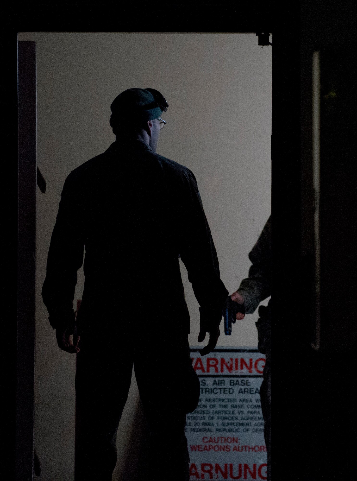 ZB-6 Marco Lorenz, 86th Security Forces Squadron tactical instructor, exits a training facility after completing a simulated active shooter training scenario Feb. 25, 2014, Ramstein Air Base, Germany. German civilian security police are an integral part to the overall security of Ramstein. (U.S. Air Force photo/Airman 1st Class Jordan Castelan)