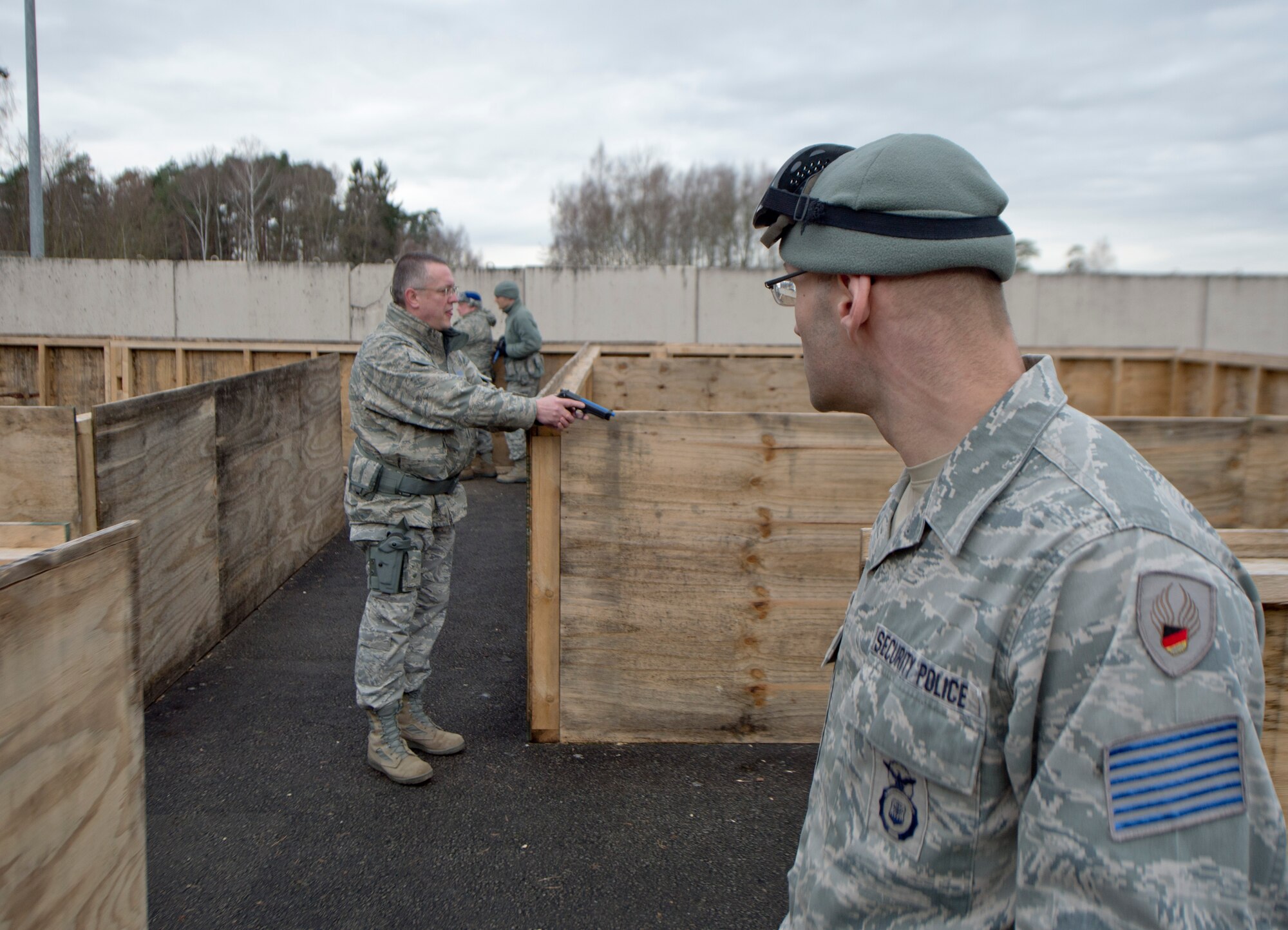 ZB-6 Marco Lorenz, 86th Security Forces Squadron tactical instructor, watches a three-student team clear a mock house during a simulated active shooter training scenario Feb. 25, 2014, Ramstein Air Base, Germany. German civilian security police are an integral part to the overall security of Ramstein. (U.S. Air Force photo/Airman 1st Class Jordan Castelan)