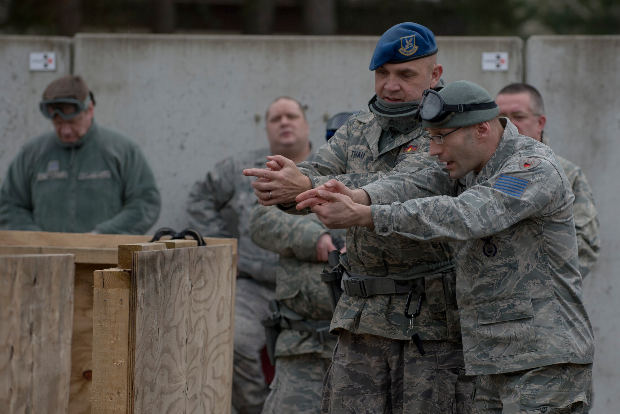 ZB-6 Marco Lorenz, 86th Security Forces Squadron tactical instructor (right), demonstrates how to safely secure a room during a simluated active shooter situation with ZP-3 Hans-Peter Thau, 86th SFS patrolman, Feb. 25, 2014, Ramstein Air Base, Germany. German civilian security police are an integral part to the overall security of Ramstein. (U.S. Air Force photo/Airman 1st Class Jordan Castelan)