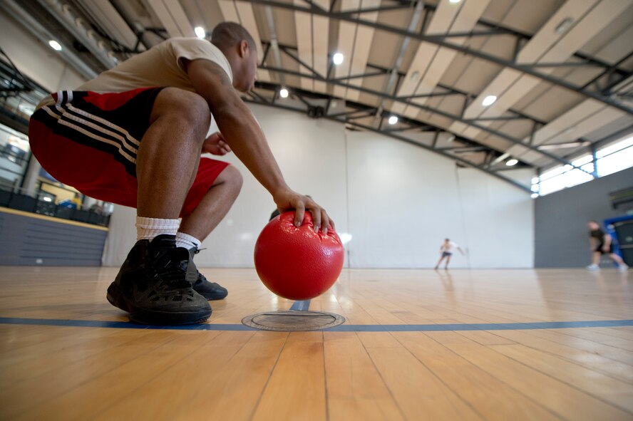 Senior Airman Jakai Alston, 1st Air and Space Communications Operations Squadron client systems technician, grabs a dodgeball shortly after the starting whistle signified the beginning of the match during a tournament organized by the 786th Force Support Squadron, February 21, 2014, Ramstein Air Base, Germany. More than 20 teams and 160 participants competed to be crowned Ramstein’s dodgeball champions. (U.S. Air Force photo/Airman 1st Class Jordan Castelan)