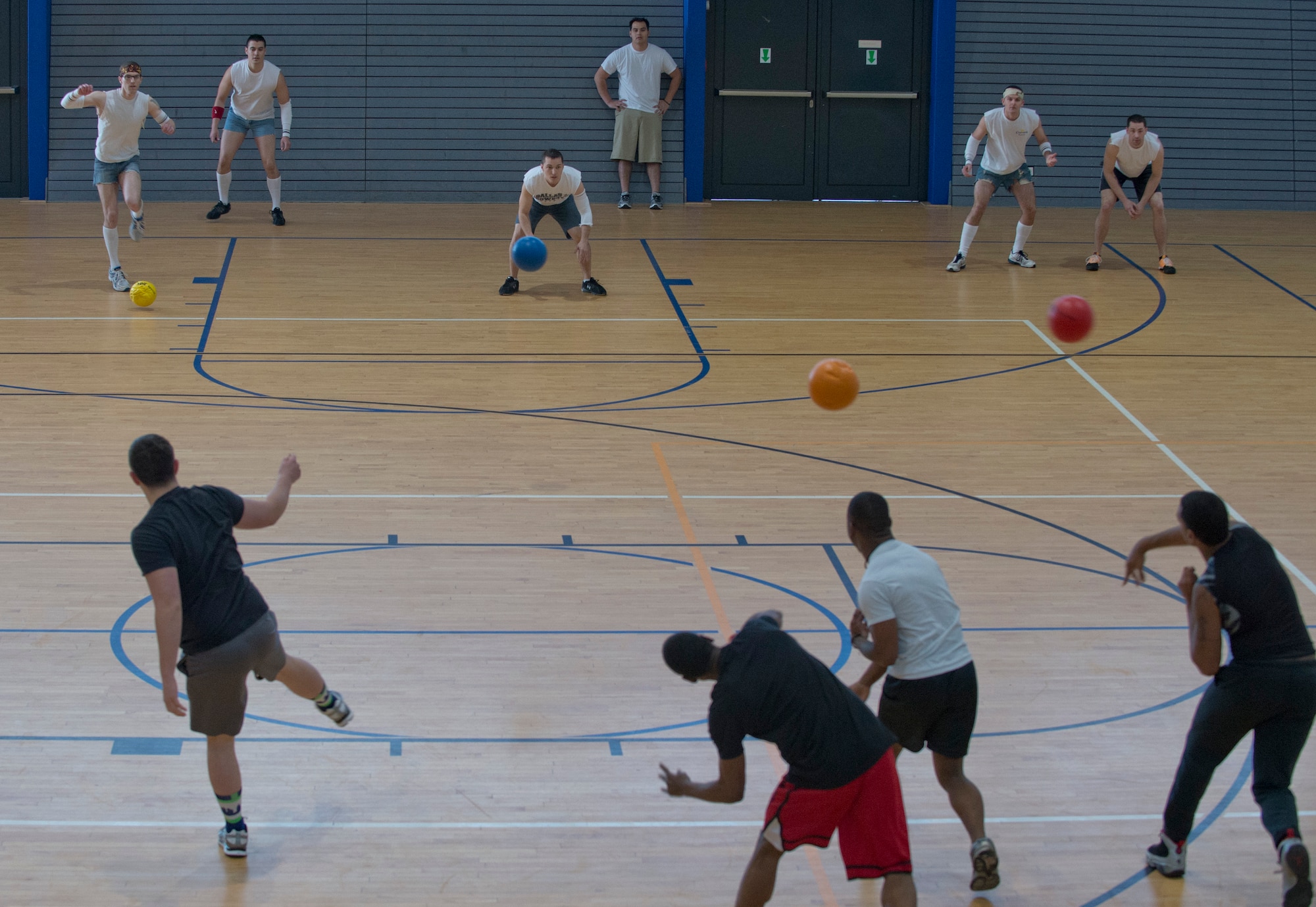 Members from the 569th U.S. Forces Police Squadron throw a volley of dodgeballs at their opponents in white from the 721st Aircraft Maintenance Squadron during a dodgeball tournament held by the 786th FSS, February 21, 2014, Ramstein Air Base, Germany. More than 20 teams and 160 participants competed to be crowned Ramstein’s dodgeball champions. (U.S. Air Force photo/Airman 1st Class Jordan Castelan) 
