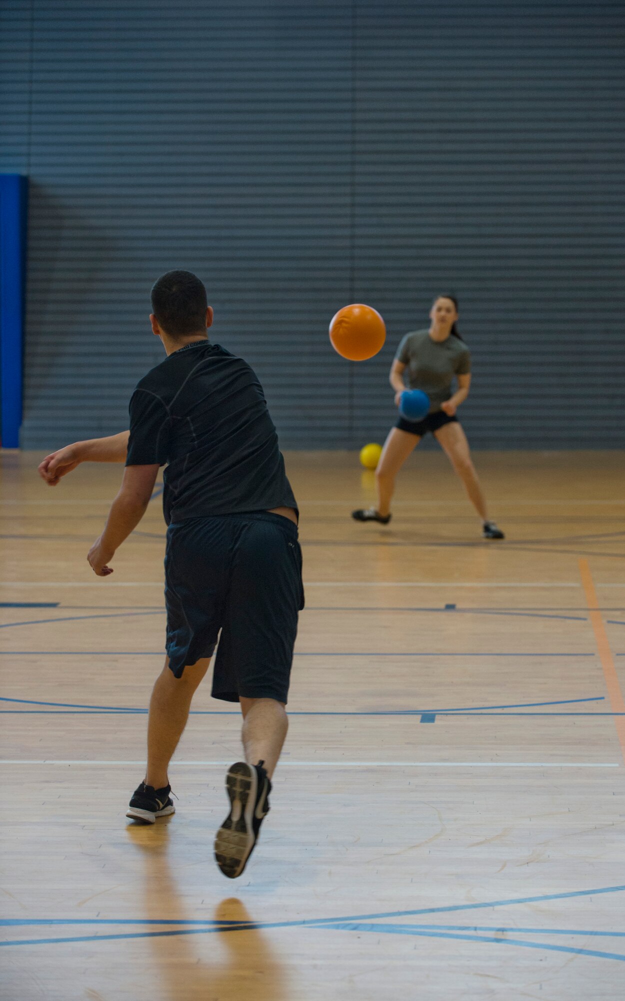 Airman 1st Class Jonathan Garcia, 352nd Network Warfare Squadron intelligence analyst, attempts to eliminate Airman 1st Class Bre Bartlett, 786th Force Support Squadron evaluation technician, and his sole remaining opponent during a dodgeball tournament held by the 786th FSS, February 21, 2014, Ramstein Air Base, Germany. More than 20 teams and 160 participants competed to be crowned Ramstein’s dodgeball champions. (U.S. Air Force photo/Airman 1st Class Jordan Castelan) 