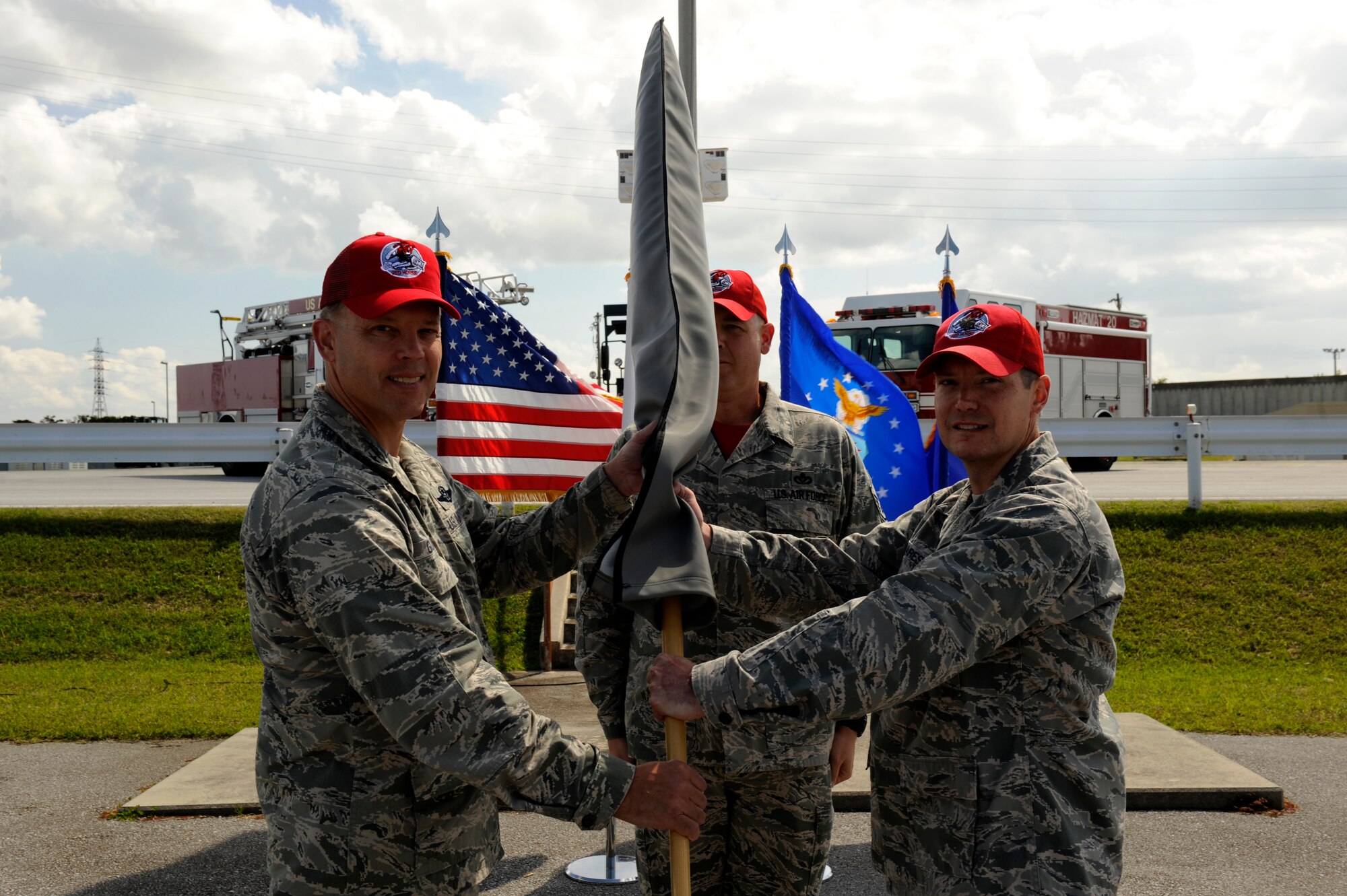 U.S. Air Force Maj. Kevin Mares, Detachment 1, 554th RED HORSE Squadron commander, passes the Detachment 1 guidon to Brig. Gen. Steve Garland, 36th Wing commander from Anderson Air Force Base, Guam, during the Silver Flag Stand Down Ceremony on Kadena Air Base, Japan, Feb. 21, 2014. The Silver Flag site has remained at Kadena since 1987, and will move to Anderson Air Force Base, Guam following the stand down. (U.S. Air Force photo by Senior Airman Maeson L. Elleman)