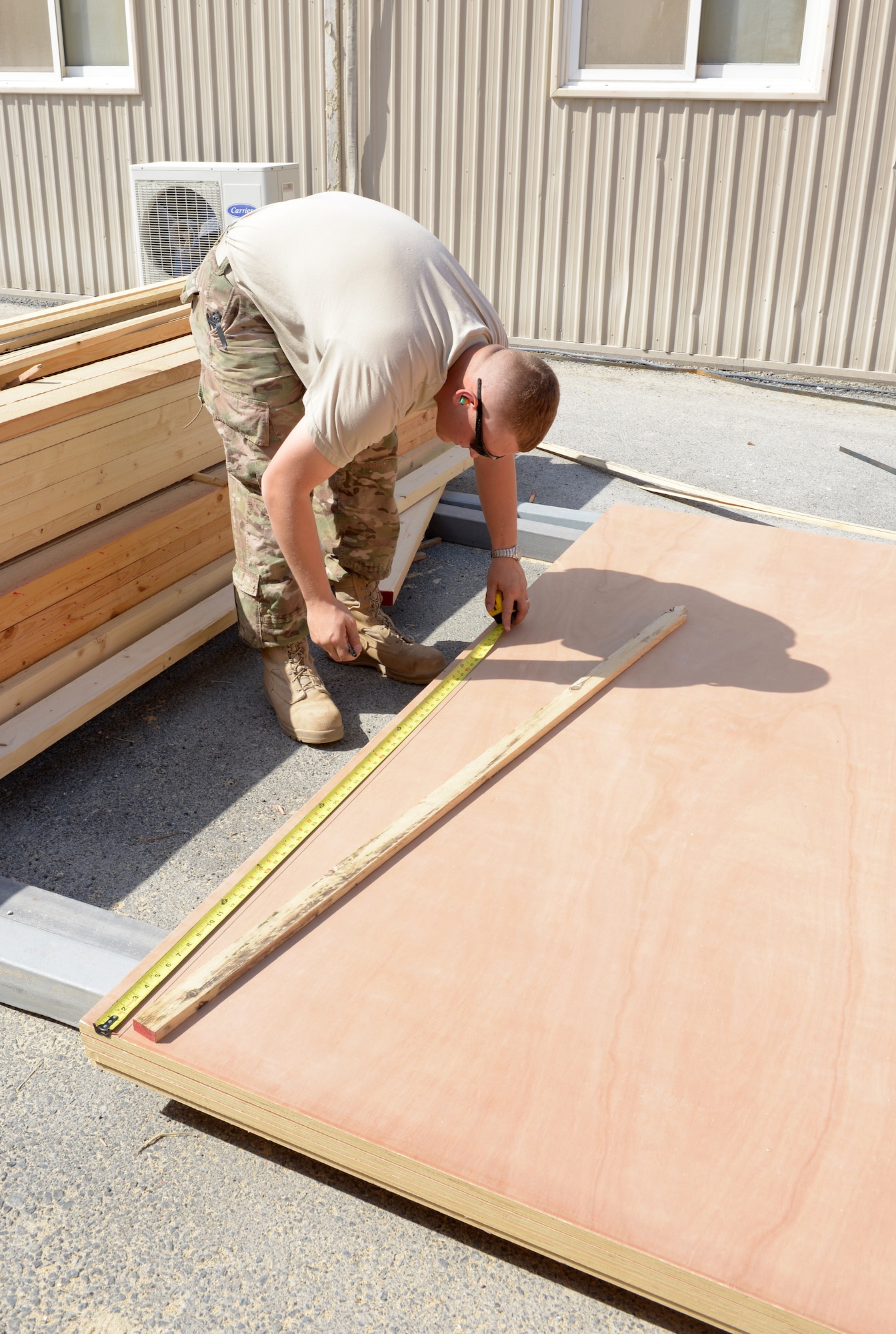 Staff Sgt. Matthew Halvorson measures plywood to finish the floor for the 31st Air Defense Artillery Brigade’s Tactical Operations Center at Al Udeid Air Base, Qatar, Feb. 24, 2014. The 577th Prime BEEF was tasked to construct a TOC to provide a robust and clear audio and visual common operating picture spanning over five nations in the Arabian Gulf region and to meet the security requirements of the 31st ADA Brigade. Halvorson is a 577th EPBS structural craftsman deployed from Ellsworth Air Force Base, S.D., and a Prior Lake, Minn., native. (U.S. Air Force photo/Senior Airman Hannah Landeros)