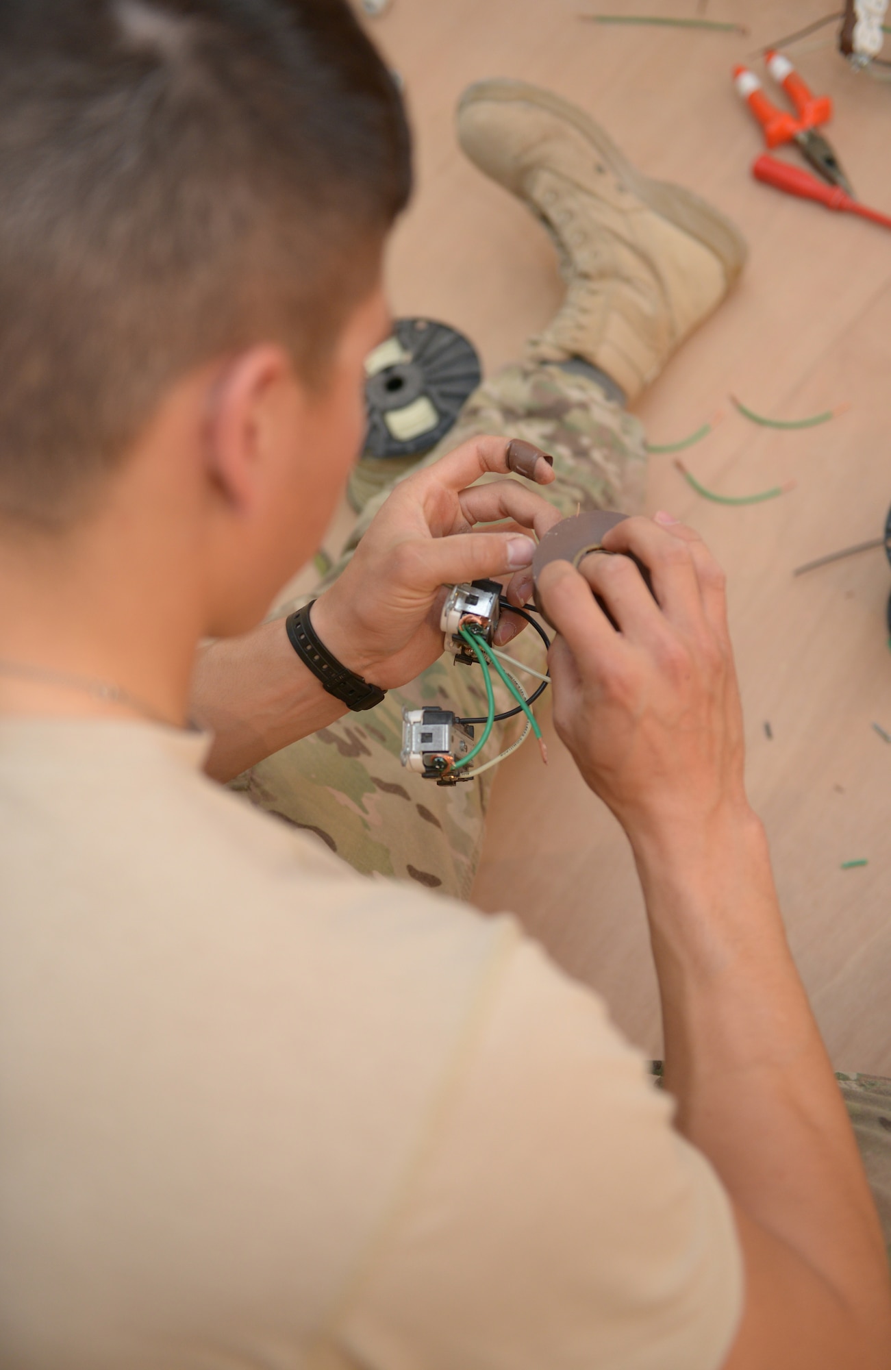 Senior Airman Jorge DeLeon builds a wall outlet for the 31st Air Defense Artillery Brigade’s Tactical Operations Center at Al Udeid Air Base, Qatar, Feb. 24, 2014. The 577th Prime BEEF was tasked to construct a TOC to provide a robust and clear audio and visual common operating picture spanning over five nations in the Arabian Gulf region and to meet the security requirements of the 31st ADA Brigade. DeLeon is a 577th EPBS engineering journeyman deployed from Holloman Air Force Base, N.M., and a Kimball, Neb., native. (U.S. Air Force photo/Senior Airman Hannah Landeros)