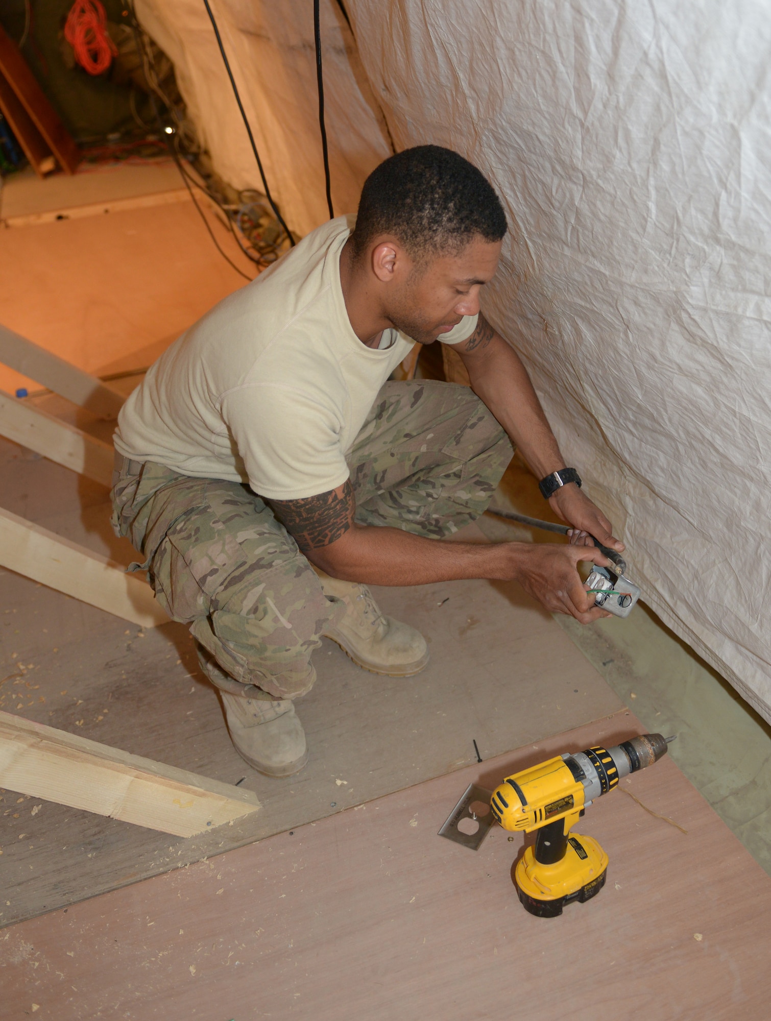 Airman 1st Class Justin Long connects an electrical outlet for a video wall at the 31st Air Defense Artillery Brigade’s Tactical Operations Center at Al Udeid Air Base, Qatar, Feb. 24, 2014. The video wall will provide a robust and clear audio and visual common operating picture spanning over five nations in the Arabian Gulf region for the 31st ADA Brigade. Long is a 577th Expeditionary Prime Base Engineer Emergency Force Squadron electrical systems journeyman deployed from Malmstrom Air Force Base, Mont., and a Tuscaloosa, Ala., native. (U.S. Air Force photo/Senior Airman Hannah Landeros)