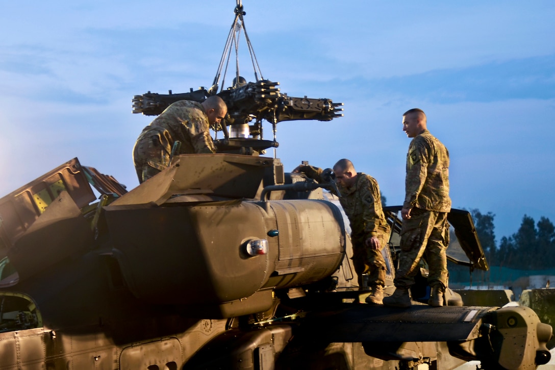 U.S. soldiers install a transmission in an AH-64 Apache helicopter on Forward Operating Base Fenty, Afghanistan, Feb. 14, 2014. The soldiers, who are maintainers, are assigned to 159th Combat Aviation Brigade. 
