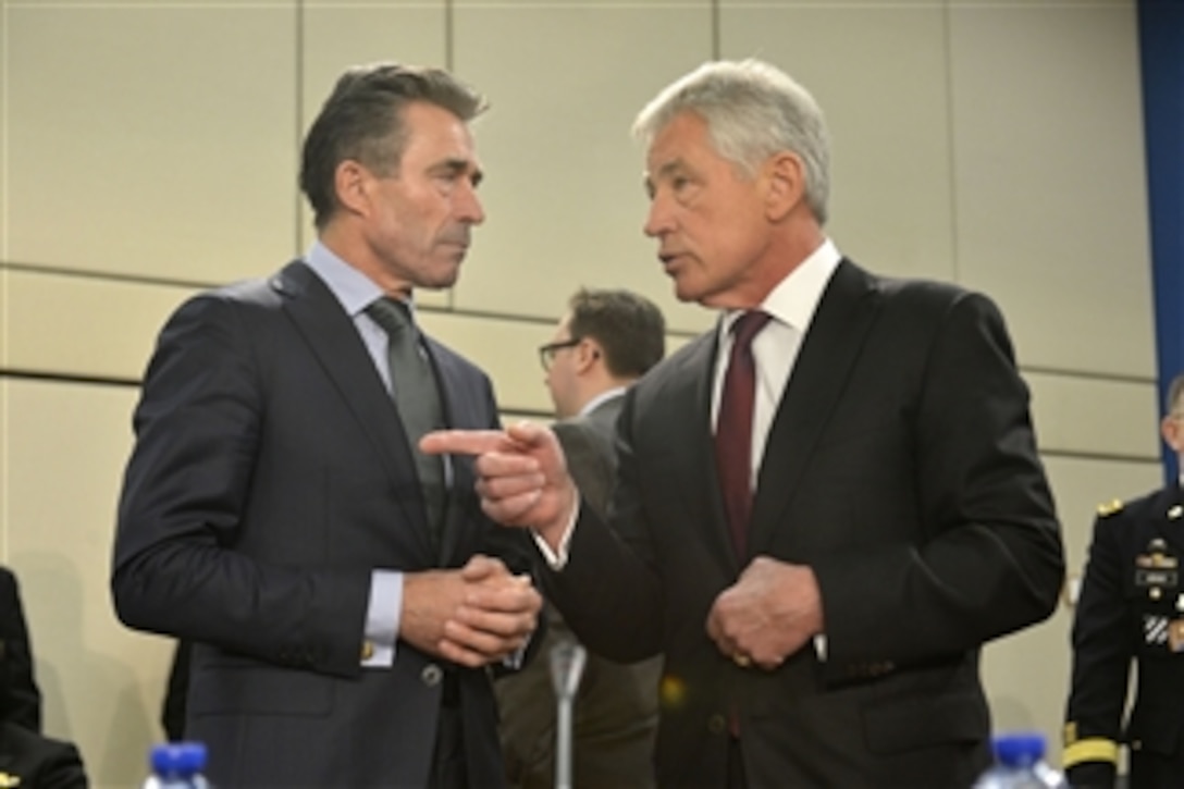 U.S. Defense Secretary Chuck Hagel, right, chats with NATO Secretary General Anders Fogh Rasmussen before a meeting of the NATO-Ukraine Commission while attending the final day of NATO defense ministerial meetings in Brussels, Feb. 27, 2014.