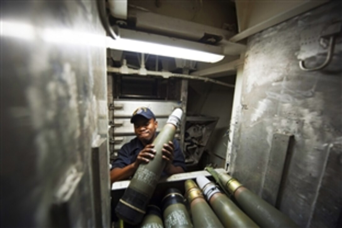 U.S. Navy Seaman Desmond Summers takes out a round from an ammunition bin for the Mk 45 5-inch lightweight gun aboard the guided-missile destroyer USS Arleigh Burke in the Atlantic Ocean, Feb. 26, 2014. The Burke is supporting maritime security operations and theater security cooperation efforts in the U.S. 5th and 6th Fleet area of operations. 