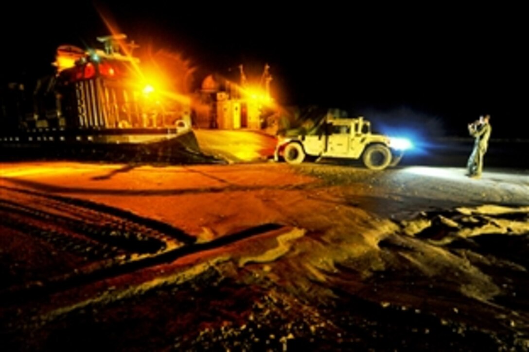 Crews load U.S. Marine Corps vehicles onto a landing craft air cushion from the multipurpose amphibious assault ship USS Bataan in Rota, Spain, Feb. 26, 2014. The Bataan Amphibious Ready Group is supporting maritime security operations and theatre security cooperation efforts in the U.S. 5th and 6th Fleet areas of responsibility. 