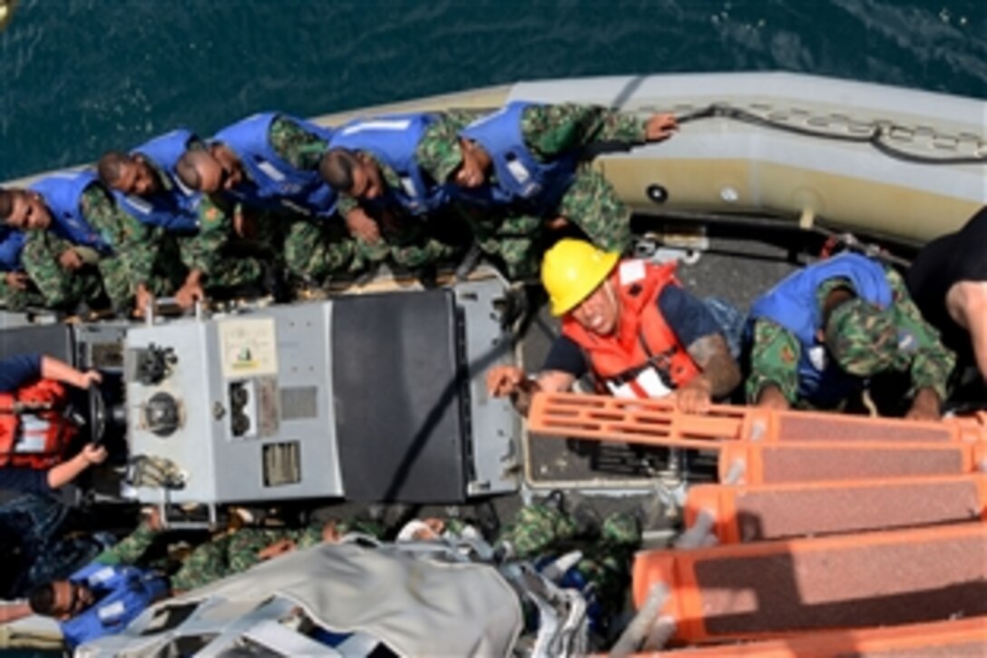 U.S. sailors and members of Timor Leste's defense force conduct rigid-hull inflatable boat training aboard the guided-missile destroyer USS Kidd during Cooperation Afloat Readiness and Training in Dili, Timor Leste, Feb. 25, 2014.