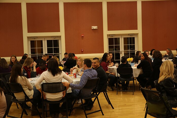 Service members with the 2nd Marine Logistics Group and their spouses enjoy dinner and camaraderie at Marston Pavilion aboard Camp Lejeune, N.C., Feb. 25, 2014. The event was held to give families a chance to meet one another and for spouses of Marines and sailors to find out about services available to them.  (U.S. Marine Corps photo by Lance Cpl. Shawn Valosin)