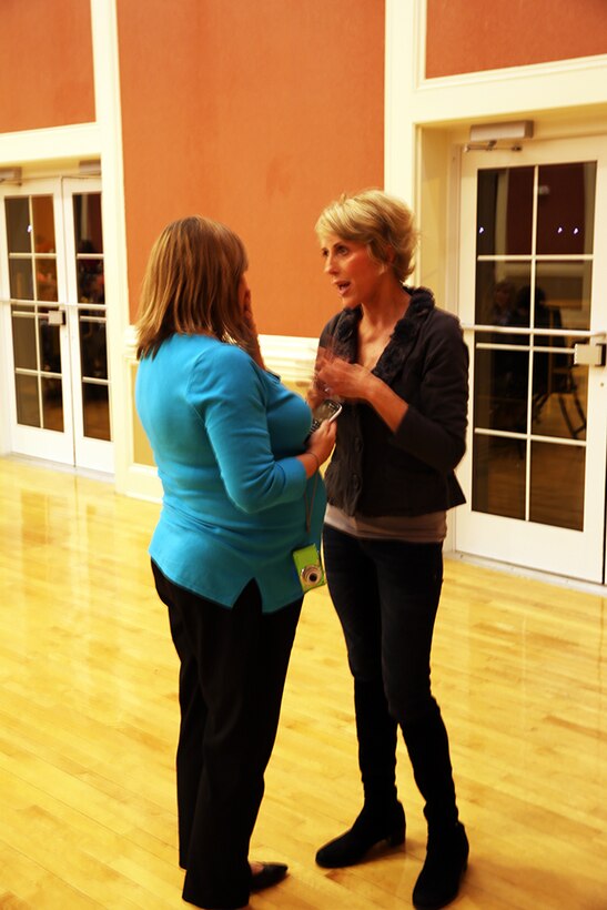 Kimberli Cooley (left), the 2nd Marine Logistics Group Family Readiness Officer speaks with Molly Banta, the wife of Brig. Gen. Edward D. Banta, the commanding general of 2nd MLG during a meet and greet that was held for the spouses of the group aboard Camp Lejeune, N.C., Feb. 25, 2014. FROs throughout the MLG worked in tandem with the Bantas in order to make the event the success it was, with more than 100 people in attendance.  (U.S. Marine Corps photo by Lance Cpl. Shawn Valosin)