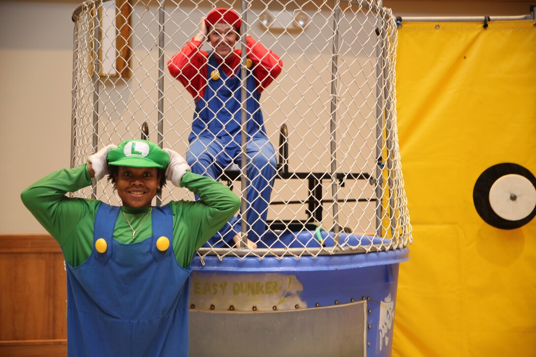 Mario and Luigi gather for a photo before taking turns in the dunk tank during a Dog’s Dream Dreamer’s Foundation’s third annual family fun day at the New Bern Convention Center, Feb. 22, 2014. More than 100 Marine Corps Air Station Cherry Point Marines and Sailors volunteered their time with some dressing up as superheroes to assist in the event. Mario and Luigi are plumbers for the Mushroom Kingdom.  