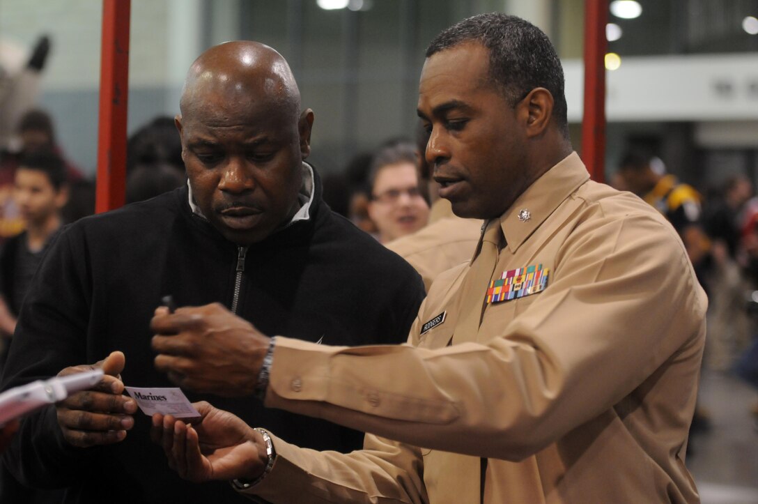 Lieutenant Col. David Rodgers, reserve support officer, Marine Corps Recruiting Command, speaks to a parent attending a career exploration event at the Charlotte Convention Center, here, Feb. 26 during the Central Intercollegiate Athletic Association (CIAA) baskeball tournament. The Marines engaged local students, parents, community inluencers and teachers to spread awareness of the Marine Corps and reinforce the idea of the armed services as a career option within the African American community. The Corps recognizes that the recruitment of qualified and skilled leaders from diverse backgrounds is essential to its future and is committed to continuing the legacy that these Marines have set forth. The CIAA consists of Historically Black Colleges and Universities (HBCU) spanning the East Coast from Pennsylvania to North Carolina. (Photo by Lance Cpl. Stanley Cao)

