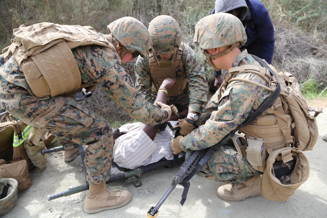 Marines with Combat Logistics Battalion 11, 11th Marine Expeditionary Unit conduct a medical evacuation as part of a resupply training scenario here Feb. 26. The mission for the training event was to equip a foreign town with supplies. During the training, Marines faced unfavorable circumstances to test their ability to make quick decisions.
