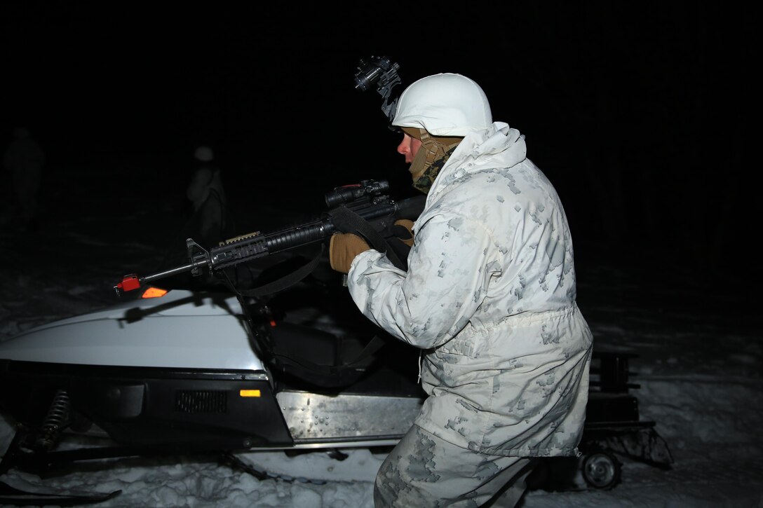 Capt. Brian Guiney, future operations officer, Marine Corps Mountain Warfare Training Center, advances alongside a squad of Marines to the enemy position as part of a long-range movement exercise aboard the training center, Feb. 20, 2014. The technical skills instructors teach help Marines maintain a combat mindset in the harshest conditions.


