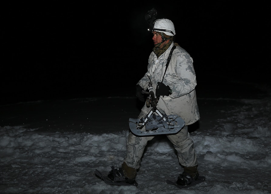 Sgt. Eric Masters, mountain leader instructor, Marine Corps Mountain Warfare Training Center, conducts a weapons check before going to the night vision live-fire range aboard the training center, Feb. 20, 2014. During the day the Marines traveled long distances, and at night coordinated battle skills while on the same challenging terrain.
