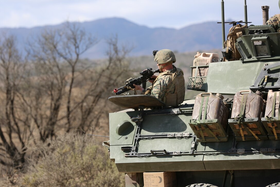 A Marine with the 1st Light Armored Reconnaissance Battalion shoulders his weapon to engage an enemy combatant firing on his squads position during a training event aboard Camp Pendleton Calif., Feb 26. Special Operations Training Group I Marine Expeditionary Force, conducted a mechanized raid for Marines from the 11th Marine Expeditionary Unit in preparation for deployment.