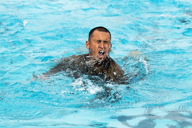 A Marine in Corporals Course conducts a 100-meter swim at the base pool aboard Marine Corps Base Hawaii, Feb. 25, 2014. The Marines were participating in Corporals Course and completed a case study that took them through several training exercises based off true scenarios Gunnery Sgt. Timothy C. Tardif experienced during Operation Iraqi Freedom, April 12, 2003. Three squad-sized teams participated in a leadership reaction course, and exercises at Boondocker Training Area to include the obstacle course and military operations on urban terrain facility and a 100-meter swim at the base pool. At the conclusion of the case study, the Marine gathered at Dewey Square to listen to Tardif explain the challenges he faced as a corporal on the battlefield and how he overcame them. U.S. Marine Corps photo by Lance Cpl. Matthew Bragg)