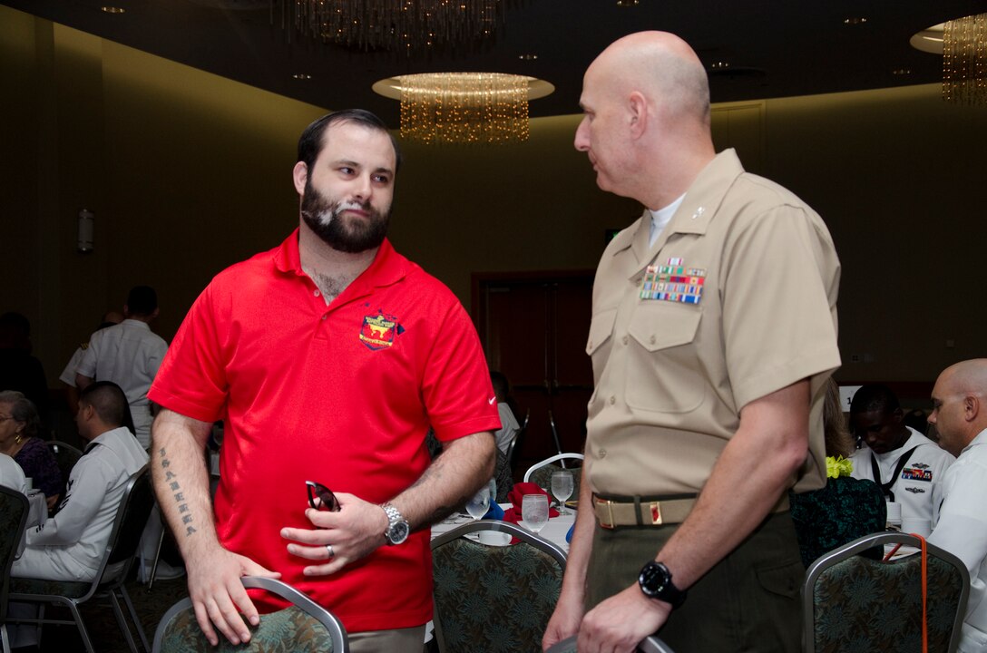 Retired Sgt. Andrew Ustaszewski, a wounded warrior with Wounded Warrior Battalion West-Detachment Hawaii, chats with Col. Joseph Spataro, G-1 chief of staff, U.S. Marine Corps Forces, Pacific, before the Honolulu Navy League’s Boots on the Ground 2014 Individual Augmentee Recognition Luncheon at the Ala Moana Hotel, Feb. 21, 2014. At the luncheon, the league recognized Marines and sailors from various units in Hawaii who served as individual augmentees. The league will no longer host the IA luncheon after this year, until there are IAs serving again. (U.S. Marine Corps photo by Kristen Wong)