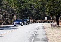 The Carolina Beach Police Department escorts Marines and sailors with General Support Maintenance Company, 2nd Maintenance Battalion, 2nd Marine Logistics Group during a hike through Carolina Beach, N.C., Feb. 27, 2014. Marines and sailors with the company hiked with approximately 70 pounds of gear at a pace of three miles per hour, stopping at historical locations for professional military education lectures. (U.S. Marine Corps photo by Lance Cpl. Shawn Valosin)