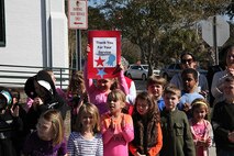 Students stand outside of Carolina Beach Elementary School with signs and American flags to greet Marines and sailors with 2nd Maintenance Battalion, Combat Logistics Regiment 25, 2nd Marine Logistics Group during a hike through Carolina Beach, N.C., Feb. 27, 2014. The nine-mile hike was used to train and educate the Marines about the Civil War battle of Fort Fisher and allow them to walk in the footsteps of those who have fought and laid down their lives for this great country. (U.S. Marine Corps photo by Lance Cpl. Shawn Valosin)