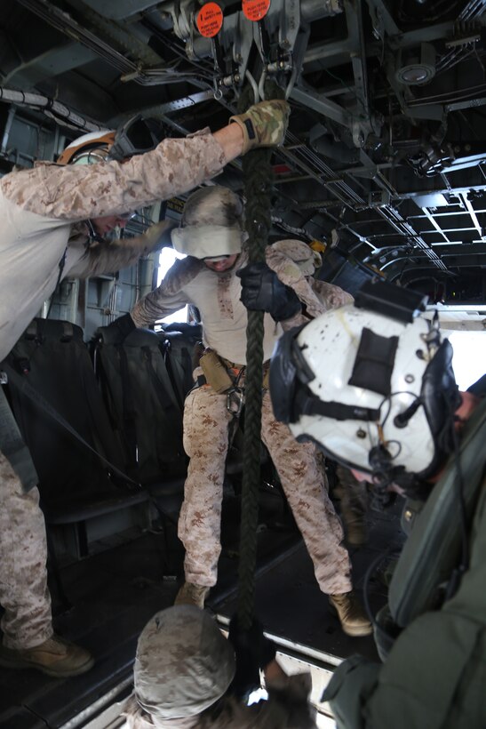 Marines with the Maritime Raid Force, 11th Marine Expeditionary Unit stabilize the rope while fellow Marines fast rope out of a CH-53E Super Stallion during a visit, board, search and seizure training here Feb. 26. VBSS missions may be utilized to conduct the maritime boarding of contested vessels. During the training, Marines fast roped down from a CH-53E Super Stallion onto a landing craft utility. The 11th MEU performs amphibious training, such as VBSS missions, to maintain skills and readiness in preparation for their upcoming deployment later this summer.   