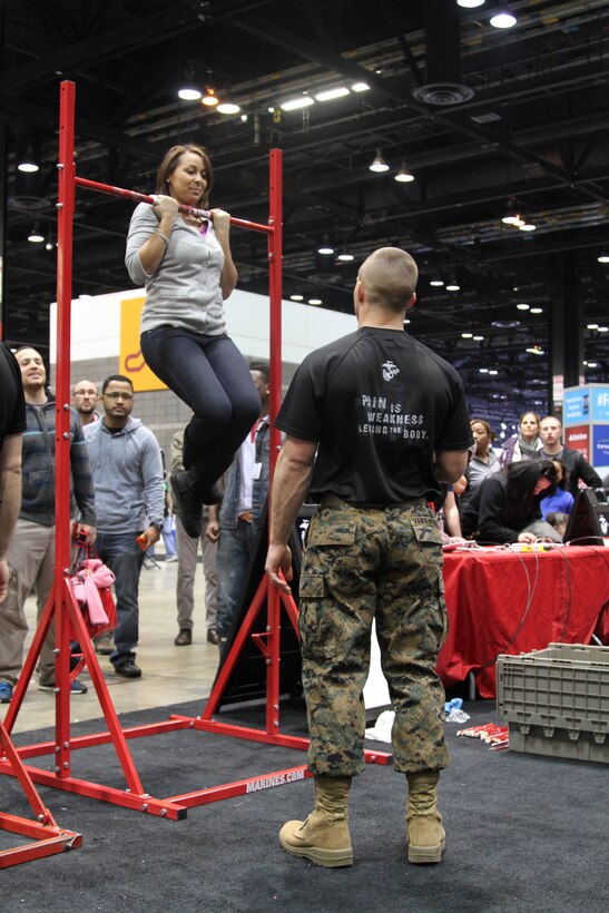 Young men and women from the Chicago area test their strength at the 9th Marine Corps District Enhanced Marketing Vehicle’s booth during the 2014 Chicago Auto Show Feb 8-17 at McCormick Place. The goal of the Marines’ appearance was to improve the knowledge about opportunities within the Marine Corps and gather information from those interested.(U.S. Marine Corps photo by Lance Cpl. Bradley Carrier)