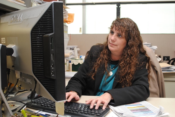 Budget analyst Tina Cox checks the balances remaining in various program accounts within Operations Division. Cox’s personal commitment to duty includes a strong work ethic and making sure she treats taxpayer money like it was her own.
