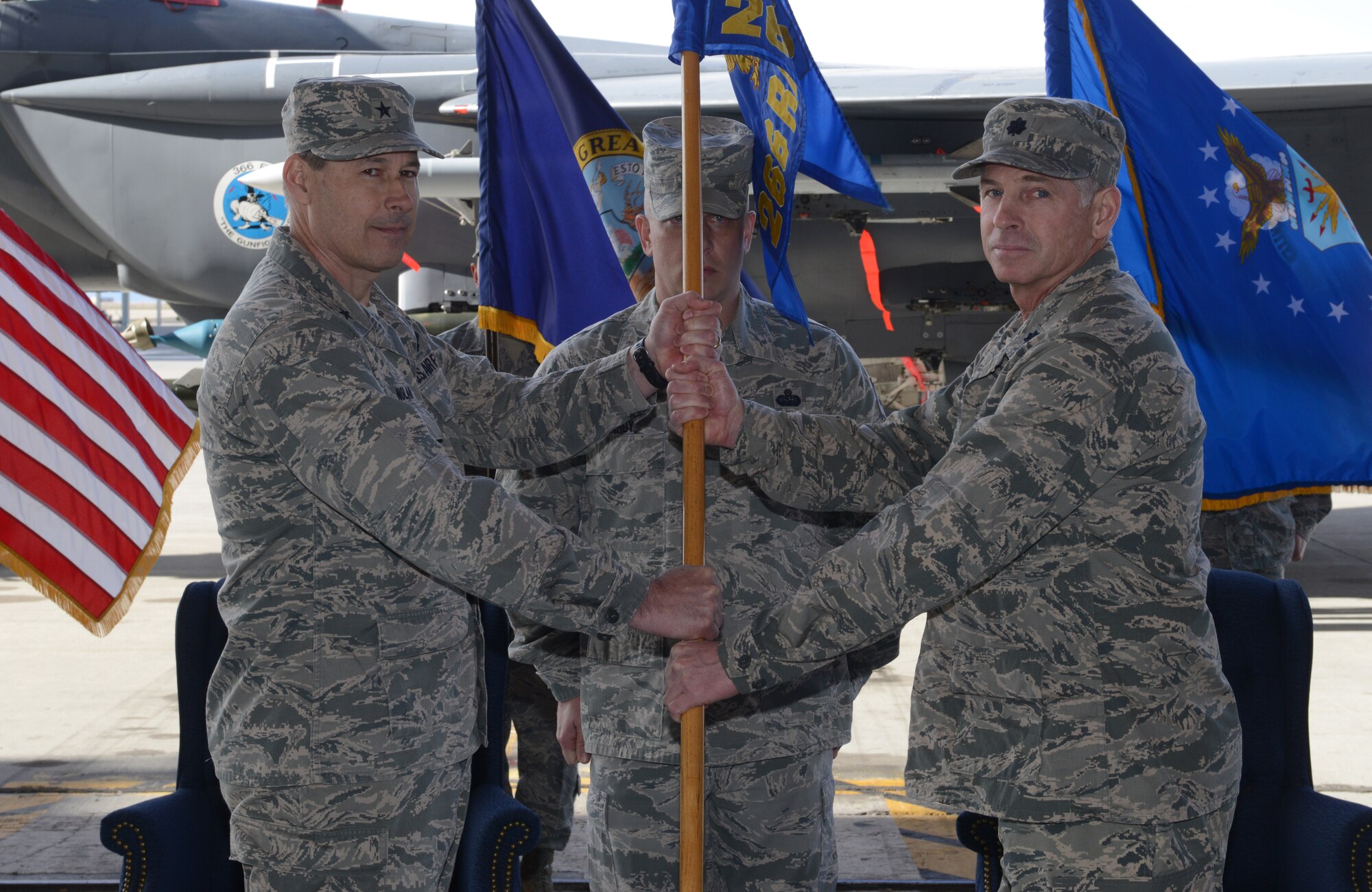 U.S. Air Force Brig. Gen. Michael Nolan, Idaho National Guard assistant adjutant general, passes the guideon to Lt. Col. Scott Downey at the assumption of commend ceremony. The ceremony took place Feb. 28, 2014 at Mountain Home AFB, Idaho. Downey’s responsibilities will include commanding 144 Air National Guard personnel. (U.S. Air Force photo by Airman 1st Class Malissa Lott/RELEASED) 
