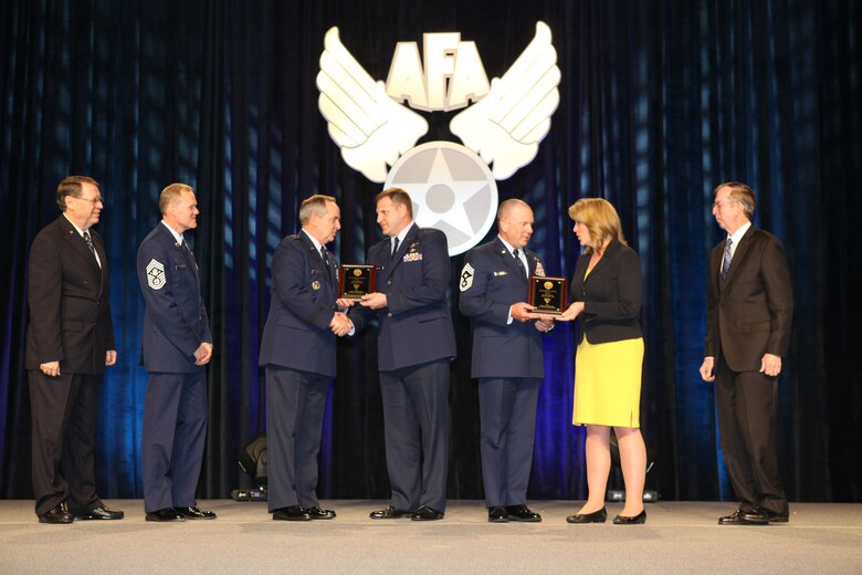 Air Force Reserve Chief Master Sgt. Gary Brown, 310th Space Wing command chief, accepts the Jimmy Doolittle Educational Fellow for Power Projection award Feb. 20, 2014, from the Honorable Deborah Lee James, Secretary of the Air Force, during the 30th Annual Air Force Association Air Warfare Symposium and Technology Exposition in Orlando, Fla. Other members on stage include (from right to left): AFA Central Florida Chapter President Bill Palmby, Maj. Michael Belardo, Air Force Chief of Staff Gen. Mark A. Welsh III, Chief Master Sergeant of the Air Force James Cody and Air Force Gala Chairman Tim Brock. (Courtesy photo/Air Force Association)