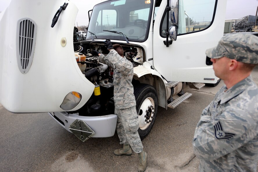 U.S. Air Force Staff Sgt. Marshall Calvin, 7th Logistics Readiness Squadron, supervises Senior Airman James Stanley, 7th Munitions Squadron, as he inspects a tractor trailer during a task evaluation Feb. 25, 2014, at Dyess Air Force Base, Texas. Task evaluations are held to ensure each Airman understands and can perform each task they are required to perform as a part of their skill level upgrade training. (U.S. Air Force photo by Airman 1st Class Alexander Guerrero/Released)