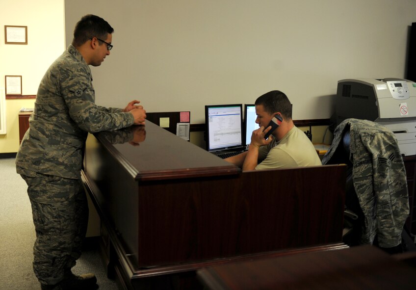 U.S. Air Force Airman Raymond Perez-Baenz, left, 7th Logistics Readiness Squadron, waits while Senior Airman Dylan Howell, right, 7th LRS, calls a vehicle from dispatch Feb. 25, 2014, at Dyess Air Force Base, Texas. Airmen from 7th LRS are responsible for moving the supplies it takes to run a base. Everything from aircraft parts to aircrews are moved by them and their vehicles. (U.S. Air Force photo by Airman 1st Class Alexander Guerrero/Released)