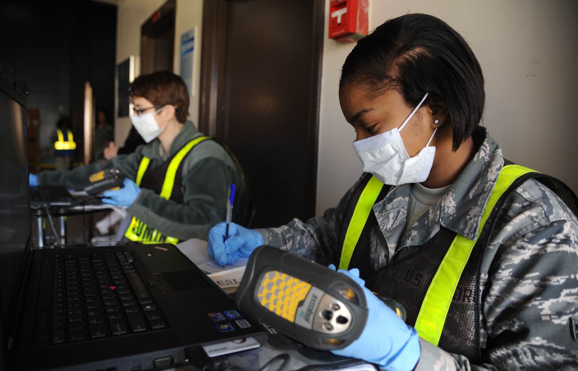Staff Sgt. Barbara Panama, 81st Surgical Operations Squadron, and Airman 1st Class Cierra Simmons, 81st Medical Support Squadron, serve as patient administration during a disease containment plan and point of dispensing exercise Feb. 27, 2014, at the Vandenberg Community Center, Keesler Air Force Base, Miss. The scenario included a steep rise in the number of patients with flu-like symptoms and the medical group distributing large quantities of influenza medications and vaccinations.  (U.S. Air Force photo by Kemberly Groue)