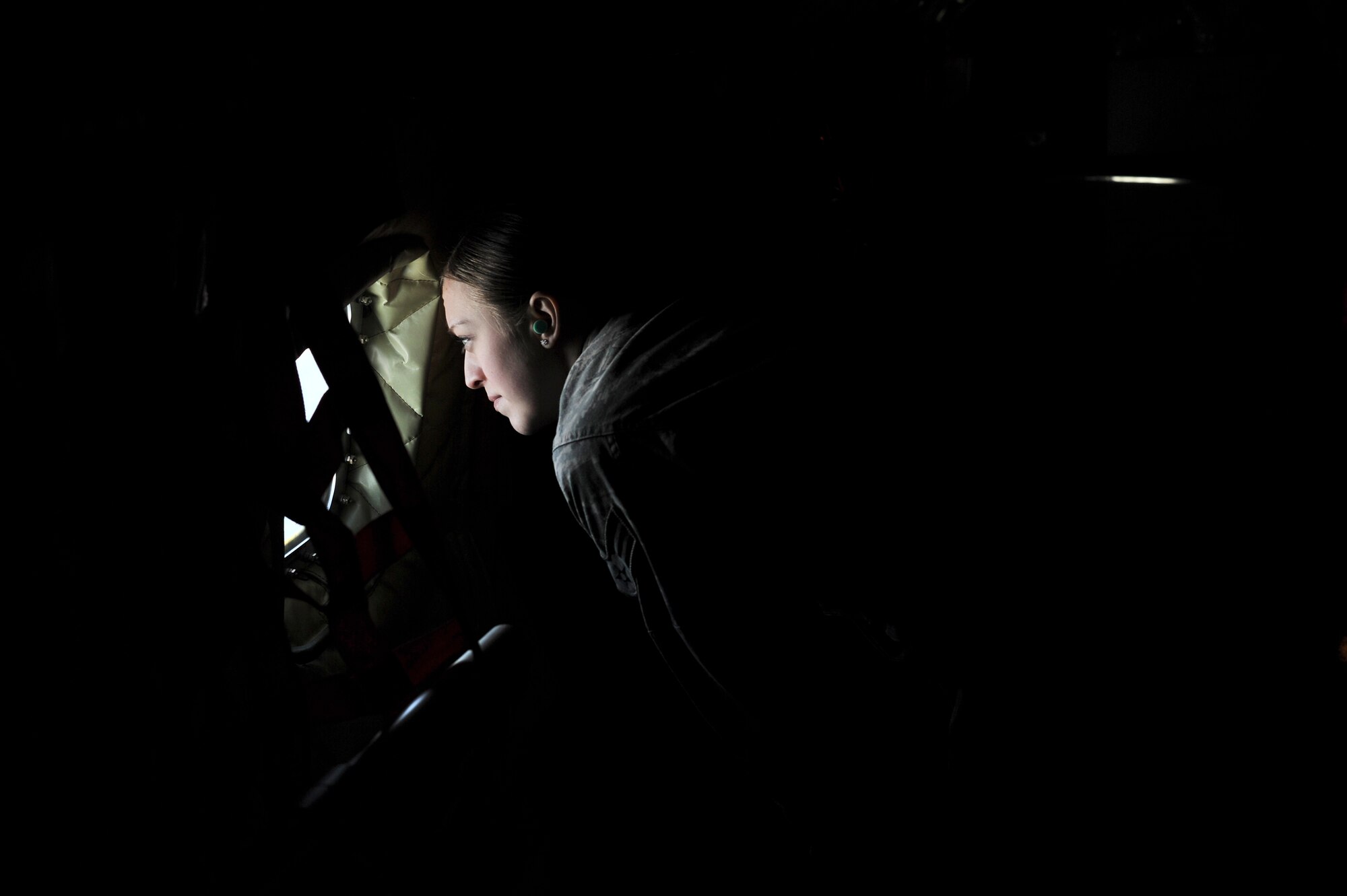 Senior Airman Brittney Black, 92nd Security Force Squadron, looks out the window of a KC- 135 Stratotanker during an incentive refueling flight over Calif., Feb. 26, 2014.  The incentive flying programs are spread throughout the Air Force to entice good morale, a sense of purpose and recognition of a job well done. (U.S. Air Force Photo by Staff Sgt. Alexandre Montes)