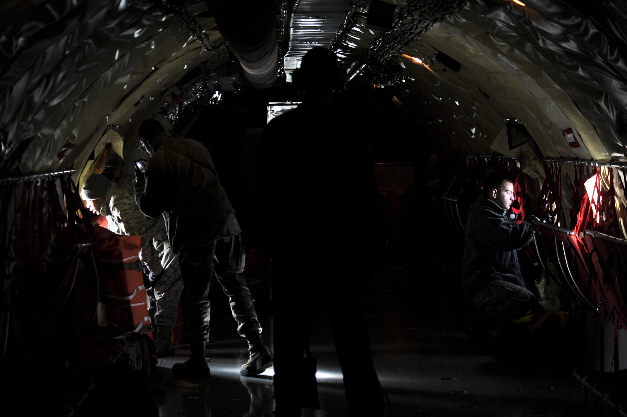 Fairchild Airmen look out the side windows of a KC-135 Stratotanker and take pictures during their incentive refueling flight over Mont. Feb. 26, 2014.  The incentive flying programs are spread throughout the Air Force to entice good morale, a sense of purpose and recognition of a job well done. (U.S. Air Force Photo by Staff Sgt. Alexandre Montes)