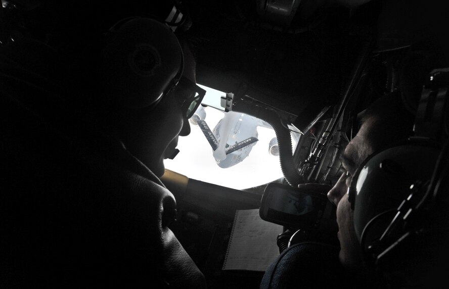 Airman First Class James Boom-Kelly, 92nd Air Refueling Squadron boom operator, explains the in-flight refueling process to Senior Airman Elijah Nigh, 92nd Logistics Readiness Squadron, during an incentive refueling flight over Calif. Feb. 26, 2014.  The incentive flying programs are spread throughout the Air Force to entice good morale, a sense of purpose and recognition of a job well done. (U.S. Air Force Photo by Staff Sgt. Alexandre Montes)